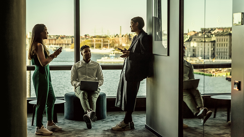 Businesspeople standing in front of a window with a view of Stockholm